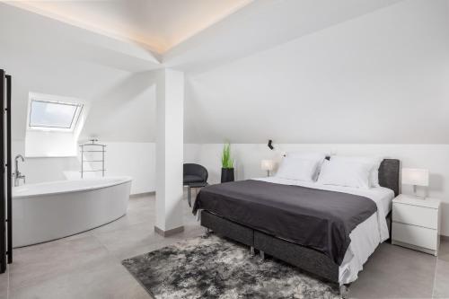a white bedroom with a bed and a bath tub at VILLA MAR - LUXURY APARTMENTS with pool and Deluxe apartment with hot tub in Selce, 20 meters from the beach in Selce