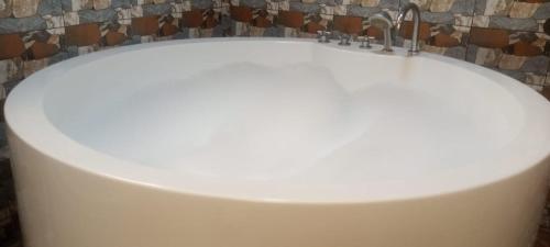a white sink with a faucet in a bathroom at Villa Flo Residence in Lomé