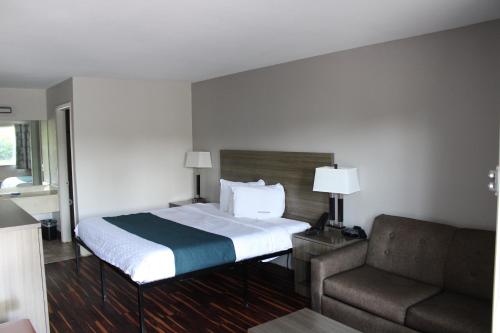 a hotel room with a bed and a couch at Suites Chattanooga TN Lookout Mtn. in Chattanooga