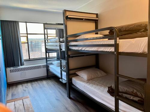 a dorm room with bunk beds and a window at HI Vancouver Downtown - Hostel in Vancouver
