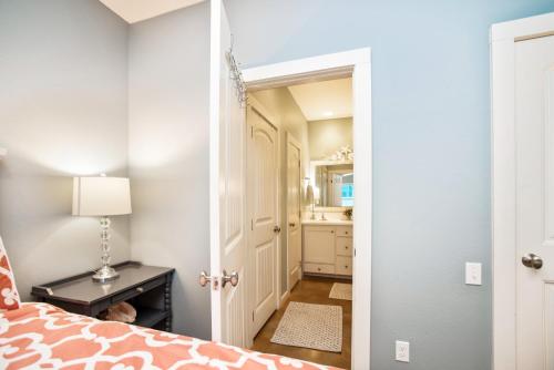 a bedroom with a bed and a bathroom at The RITZ Tarpon- VW 83 in Port Aransas