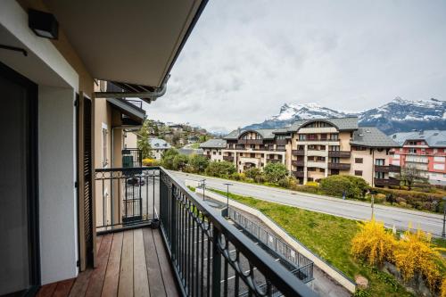 a balcony with a view of a street and mountains at A magnificent apartment in the beautiful French mountains in Saint-Gervais-les-Bains