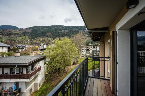 a balcony with a view of a city at A magnificent apartment in the beautiful French mountains in Saint-Gervais-les-Bains