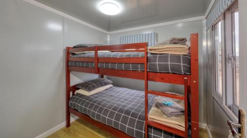 two bunk beds in a small room with at White Cliffs Self Contained Cabin Accommodation in White Cliffs