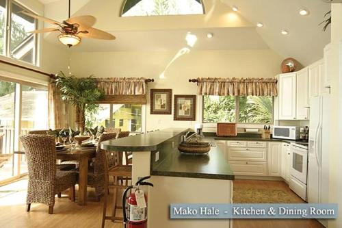 a kitchen with a table and a dining room at Beachfront Villa North Shore Oahu in Haleiwa