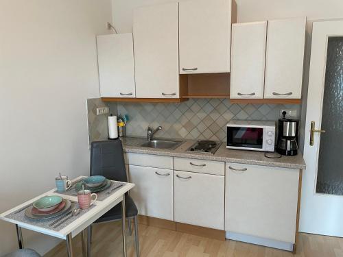 a small kitchen with a table and a microwave at Fürstner Haus 