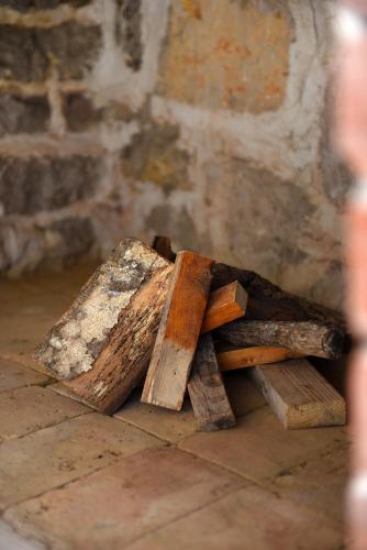 a pile of pieces of wood sitting on the floor at Holiday Stone House - Fumarea in Rtina