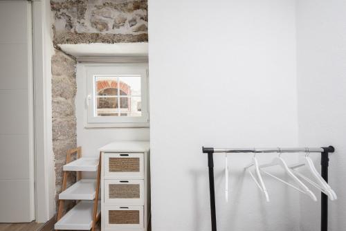 a room with white walls and white shelves at Holiday Stone House - Fumarea in Rtina