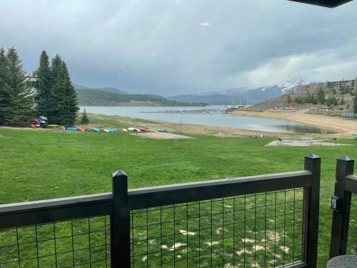 a view of a field with a fence and a body of water at Lakefront Luxury Condo with Stunning Views!! in Dillon