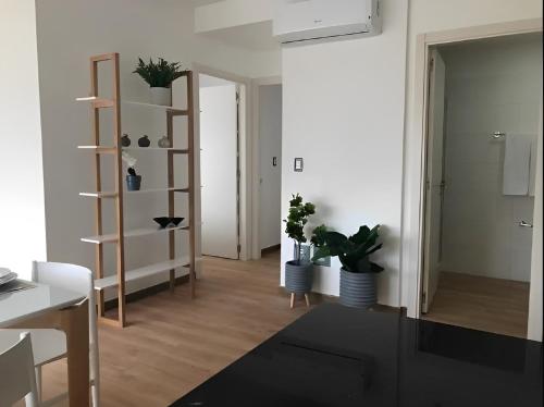 a living room with plants and a book shelf at Impressive Family City View Apt B - PH Quartier Marbella in Panama City