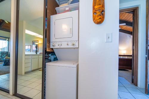 a kitchen with a washer and dryer in a house at Papakea E406 in Kahana