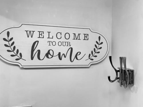 a welcome to our home sign on a wall at Station House in Ballina