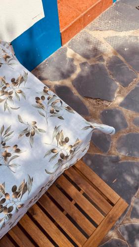 a couch with a floral pattern on it sitting on a stone floor at Monte do Pópulo in Estremoz