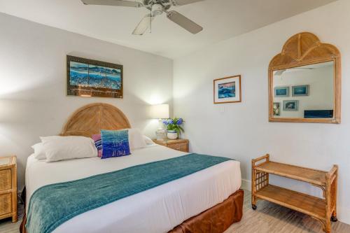 a bedroom with a large bed and a mirror at Paki Maui 403 in Kahana