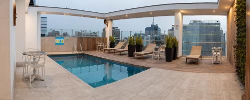 a swimming pool on the roof of a building at Hotel Britania Crystal Collection in Lima