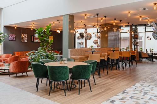 a restaurant with tables and chairs and a bar at Hotel Berlin, Berlin, a member of Radisson Individuals in Berlin