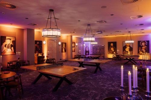 a room with ping pong tables and chandeliers at Hotel Berlin, Berlin, a member of Radisson Individuals in Berlin