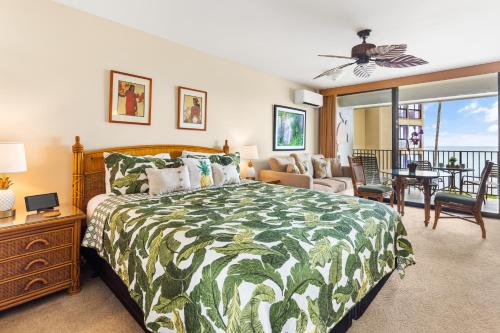a bedroom with a bed and a living room at Noelani 213 in Kahana