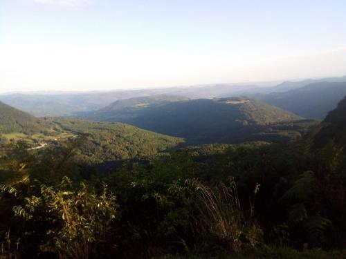 a view from the top of a mountain with trees at Chalé alpino em canela rs todo mobiliado com cozinha lareira split Wi-Fi 2 quartos perto do centro in Canela