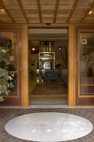 a glass door of a building with a chair in it at Hotel Eden in Naples