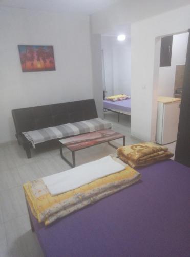 a living room with a couch and a table at Aleksandros Apartments in Paralia Katerinis