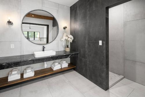 a bathroom with a sink and a mirror at McGregor & Main - Luxury Lofts in Hill City