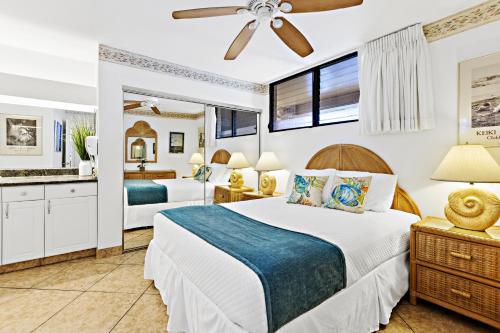 a bedroom with two beds and a bathroom at Paki Maui 326 in Kahana
