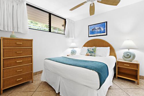 a bedroom with a bed and a dresser and a bed at Paki Maui 326 in Kahana