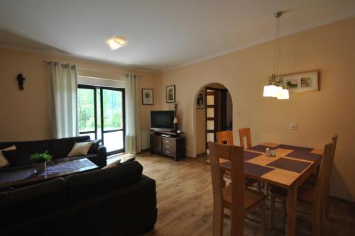 a living room with a table and a dining room at Apartamenty Belweder - Sun Seasons 24 in Wisła