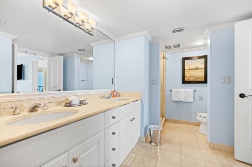 a bathroom with a sink and a toilet at Seashells and Sunshine Marco Beach Ocean Resort 1105 in Marco Island