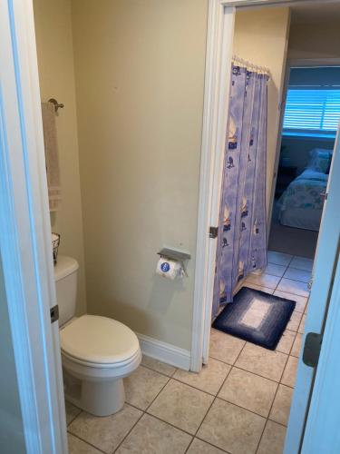 a bathroom with a toilet and a shower at Oak Shores. in Biloxi
