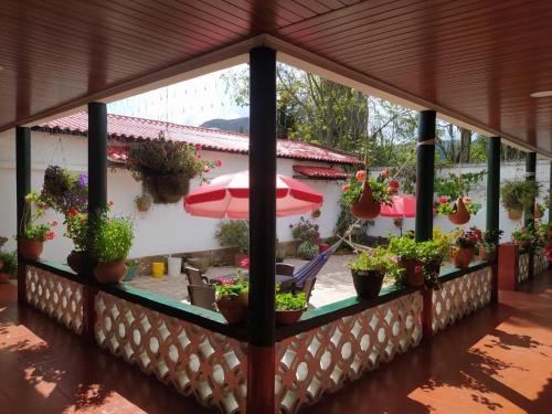 a porch with potted plants and an umbrella at Villa Alioc in Iza