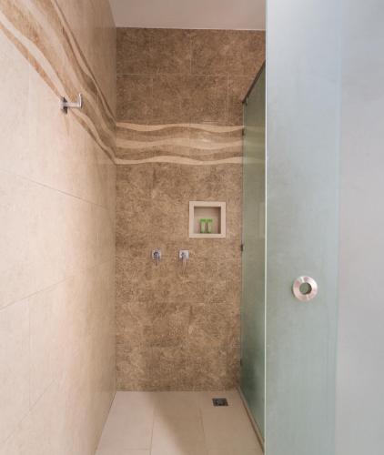 a shower with a glass door in a bathroom at Hotel La Mariposa in Manuel Antonio