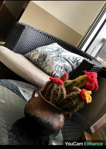 a vase with chickens in it next to a couch at Hotel La Terminal in San Miguel de Tucumán