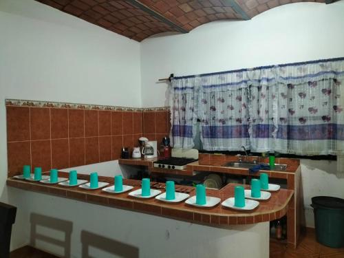 a kitchen with a counter with green bowls on it at Casa las cabras in La Peñita de Jaltemba