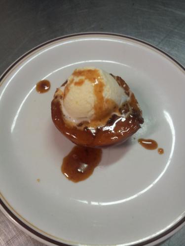 a white plate with a doughnut with ice cream on it at Hotel Saturno in Chianciano Terme