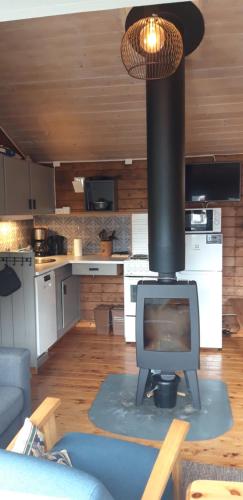 a living room with a television and a stove at Stalheim Fjord og Fjellhytter in Stalheim