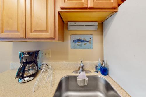 a kitchen counter with a sink and a mixer at Driftwood Villa - 240 in Edisto Island