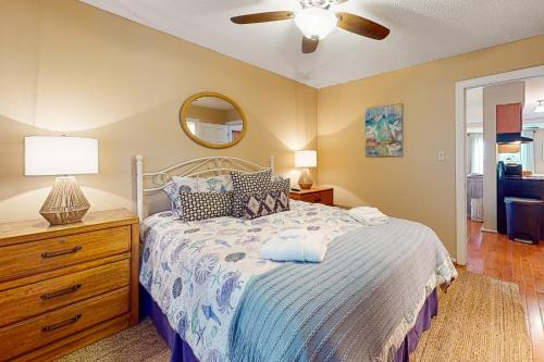 a bedroom with a bed and a ceiling fan at Driftwood Villa - 240 in Edisto Island