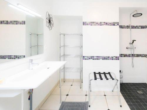 a bathroom with a sink and a mirror at Gîte Laneuveville-devant-Bayon, 5 pièces, 9 personnes - FR-1-584-15 