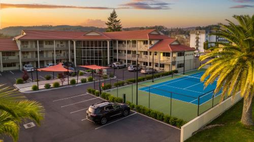 an aerial view of a hotel with a tennis court at Regal Palms Resort in Rotorua