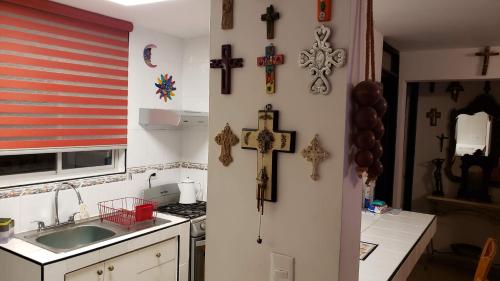 a kitchen with a cross and crosses on the wall at La Finca in Monterrey