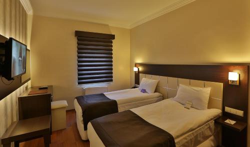 Säng eller sängar i ett rum på Gaziantep Garni Hotel