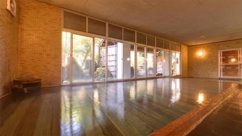 an empty dance floor in a room with windows at Hosenji Kanko Hotel Yumotoya in Kokonoe