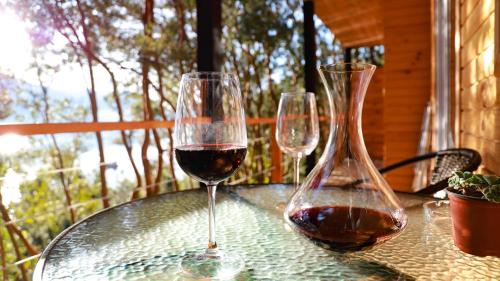 two glasses of wine sitting on a table at Cabañas Loft Alto Arrayan Cochamó in Cochamó