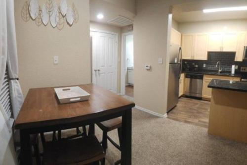 a kitchen with a table and a kitchen with a refrigerator at LUX COMFORT in Arlington