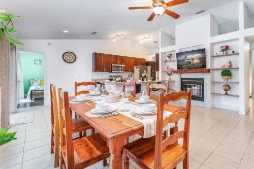 a kitchen and dining room with a wooden table and chairs at The Pelican/Pool/HotTub/GameRoom in Brandon
