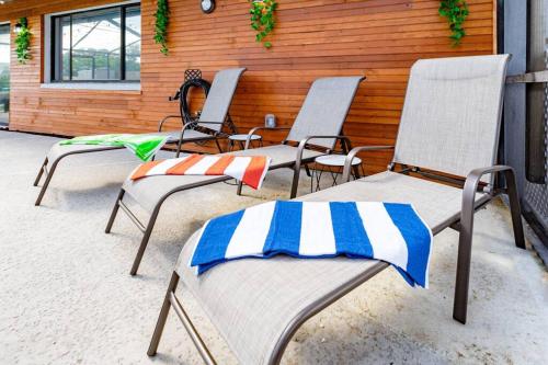 a group of chairs sitting on a patio at The Pelican/Pool/HotTub/GameRoom in Brandon