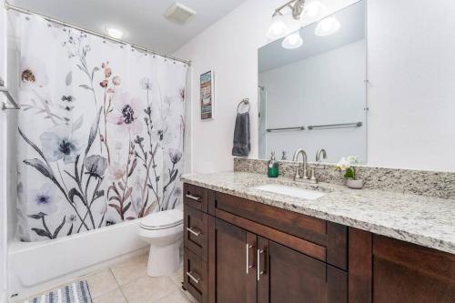 a bathroom with a sink and a toilet and a shower at The Pelican/Pool/HotTub/GameRoom in Brandon