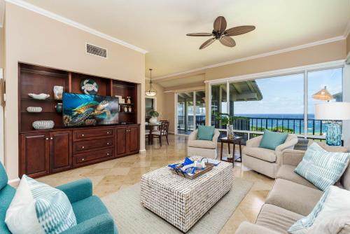 a living room with a couch and a tv at Kapalua Bay Villa 29B4 villa in Kahana